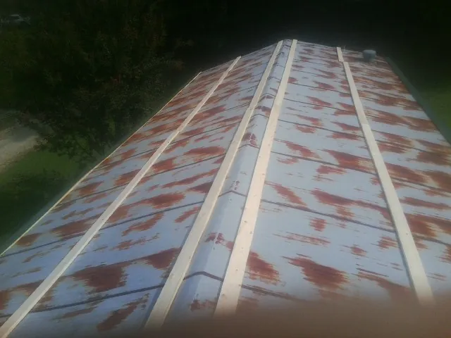 Rusted metal roof panels with new wood purlins before replacement — Storm Damage Roof Repair in Flanders by Roofing Brothers