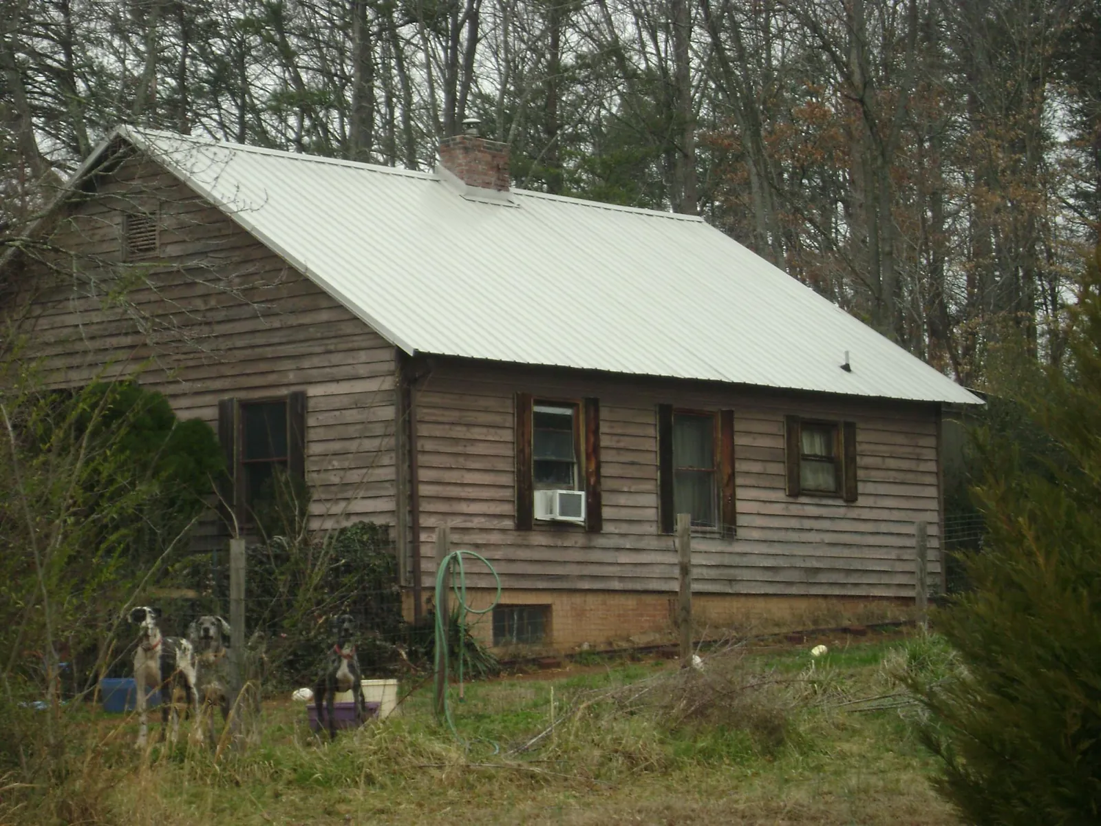 White metal roof on an old wood sided farmhouse, from a Metal Roof Installation job in Flanders